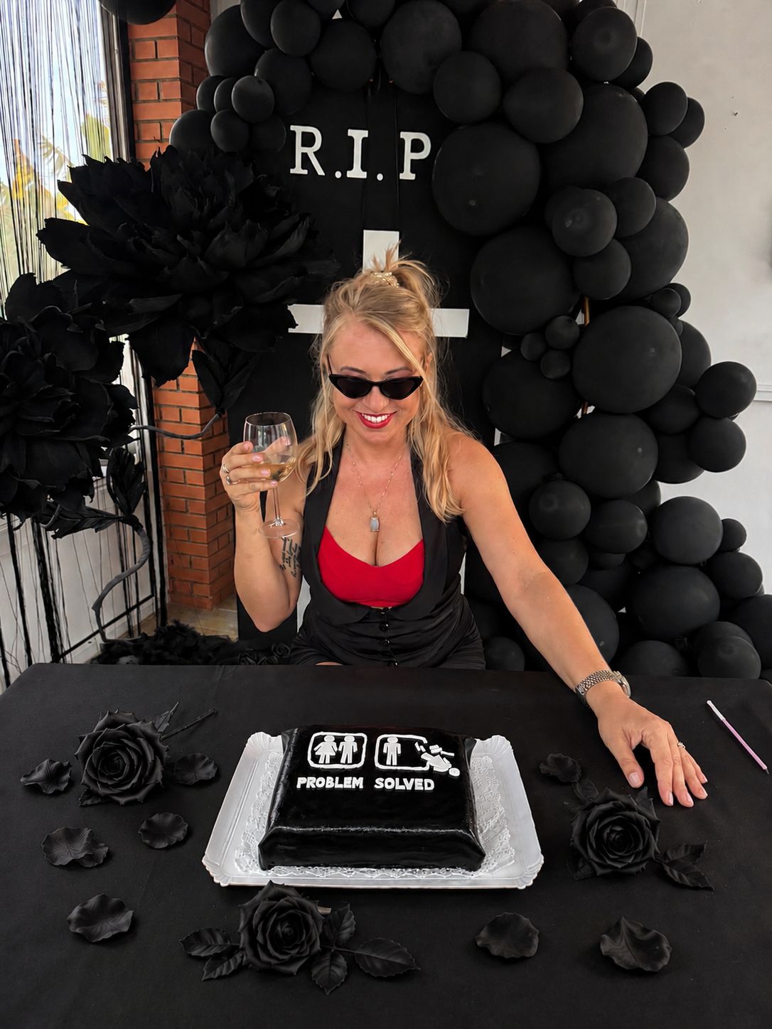 Divorce party celebration with a black cake and balloons